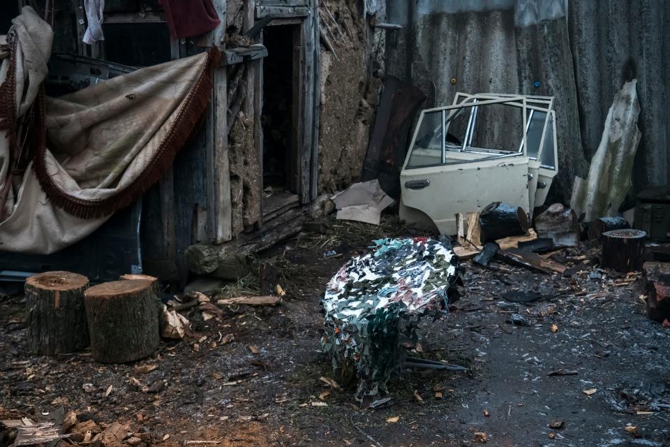 A Starlink antenna covered with a camouflage net stands in the location of a unit of the Armed Forces of Ukraine in the Donetsk region, Ukraine, December 2022