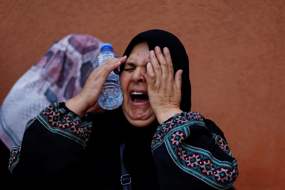 Palestinians mourn during the funeral of Palestinian nurse Haniyeh Qudih, who was killed in an Israeli strike, in Khan Younis (REUTERS)