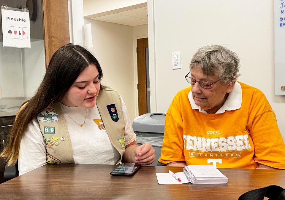 Oak Ridge Girl Scout Ashli Allison helps resident Mary McKeethan with some smartphone questions at the Oak Ridge Senior Center.