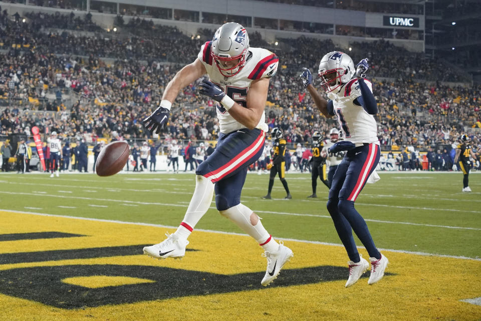 New England Patriots tight end Hunter Henry (85) celebrates after scoring as teammate Tyquan Thornton, right, watches during the first half of an NFL football game against the Pittsburgh Steelers on Thursday, Dec. 7, 2023, in Pittsburgh. (AP Photo/Gene J. Puskar)