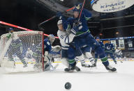 Vancouver Canucks goaltender Thatcher Demko (35) looks back as Toronto Maple Leafs left wing Zach Hyman (11) fights for control of the puck with Canucks defenseman Tyler Myers (57) during the second period of an NHL hockey game Thursday, March 4, 2021, in Vancouver, British Columbia. (Jonathan Hayward/The Canadian Press via AP)