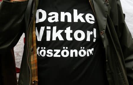 A supporter of the Hungarian Prime Minister Viktor Orban, wearing a shirt with a slogan reading "Thank you Viktor!", stands during a CSU party event in Kloster Banz near Bad Staffelstein, Germany September 23, 2015. REUTERS/Michael Dalder