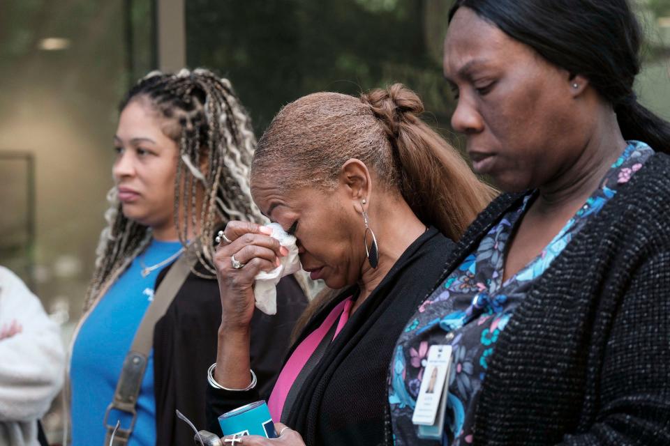 People stand outside a commercial building after a shooting, Wednesday, May 3, 2023, in Atlanta. Atlanta police said there had been no additional shots fired since the initial shooting unfolded inside a building in a commercial area with many office towers and high-rise apartments.