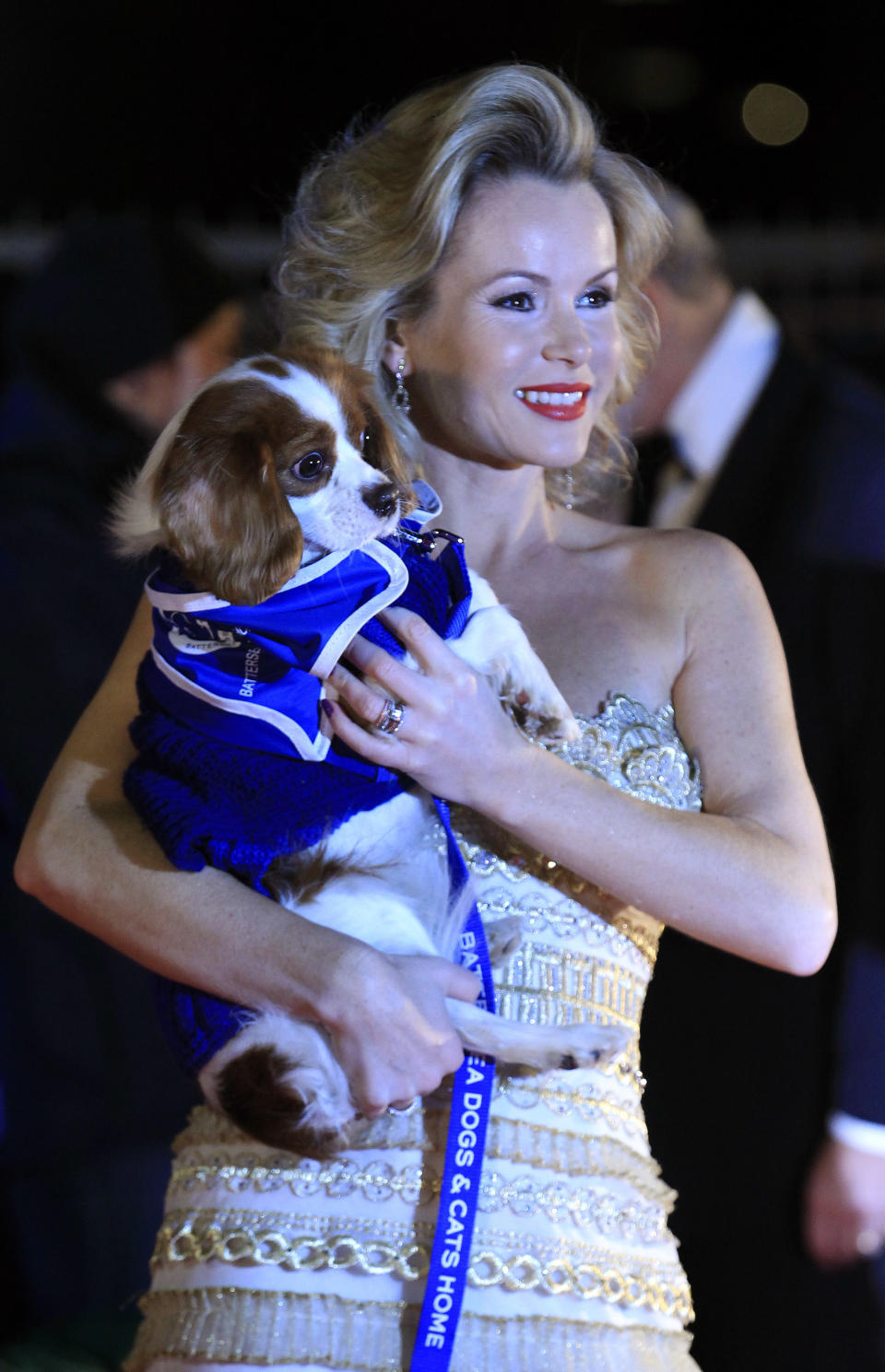 Actress Amanda Holden poses on the red carpet with a dog attending the Battersea Dogs and Cats Home's 150th year "Collars and Coats Gala Ball" at Battersea Power Station in London, November 25, 2010.  REUTERS/Luke MacGregor (BRITAIN - Tags: ENTERTAINMENT ANIMALS SOCIETY)