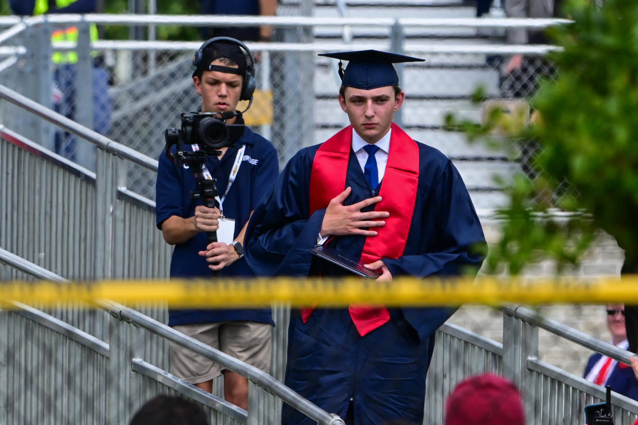 Barron Trump, in cap and gown, takes part in his graduation at Oxbridge Academy in Palm Beach, Fla. in May.