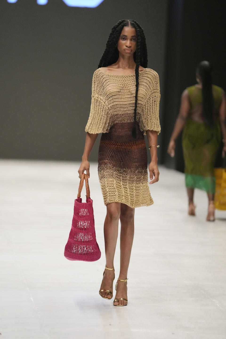 A model displays a creation by Imo during the Lagos Fashion Week in Lagos, Nigeria, Thursday, Oct. 26, 2023. Africa's fashion industry is rapidly growing to meet local and international demands but a lack of adequate investment still limits its full potential, UNESCO said Thursday in its new report released at this year's Lagos Fashion Week show. (AP Photo/Sunday Alamba)