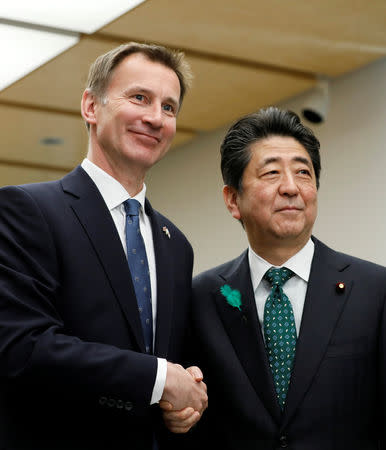 Jeremy Hunt, British Secretary of State for Foreign and Commonwealth Affairs, shakes with Japanese Prime Minister Shinzo Abe (R) during a courtesy call at the latter's official residence in Tokyo, Japan, 15 April 2019. Kimimasa Mayama/Pool via REUTERS