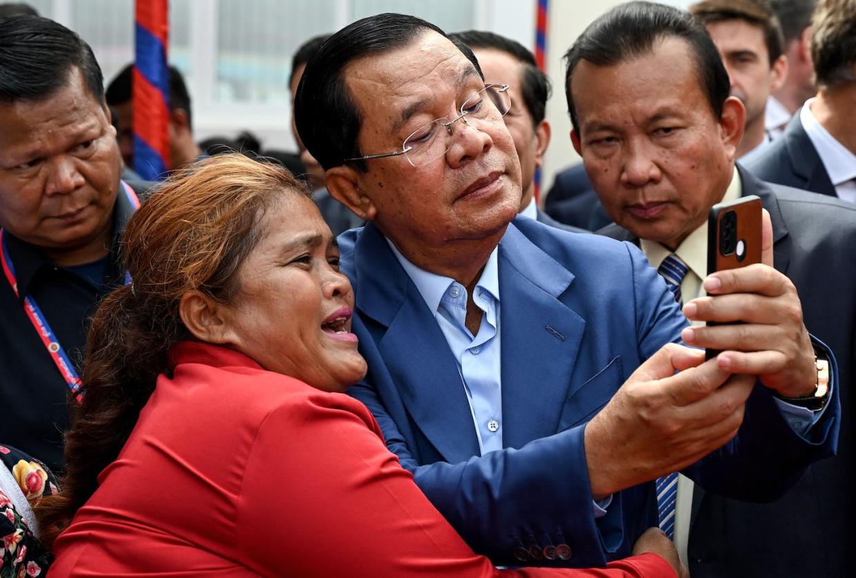 Cambodian PM <span class="caas-xray-inline-tooltip"><span class="caas-xray-inline caas-xray-entity caas-xray-pill rapid-nonanchor-lt" data-entity-id="Hun_Sen" data-ylk="cid:Hun_Sen;pos:1;elmt:wiki;sec:pill-inline-entity;elm:pill-inline-text;itc:1;cat:Politician;" tabindex="0" aria-haspopup="dialog"><a href="https://search.yahoo.com/search?p=Hun%20Sen" data-i13n="cid:Hun_Sen;pos:1;elmt:wiki;sec:pill-inline-entity;elm:pill-inline-text;itc:1;cat:Politician;" tabindex="-1" data-ylk="slk:Hun Sen;cid:Hun_Sen;pos:1;elmt:wiki;sec:pill-inline-entity;elm:pill-inline-text;itc:1;cat:Politician;" class="link ">Hun Sen</a></span></span> takes a selfie -- but where will he post it now? <a href="https://www.gettyimages.com/detail/news-photo/cambodias-prime-minister-hun-sen-takes-selfies-with-a-news-photo/1258807502?adppopup=true" rel="nofollow noopener" target="_blank" data-ylk="slk:Rang Xhhin Sothy/AFP via Getty Images;elm:context_link;itc:0;sec:content-canvas" class="link ">Rang Xhhin Sothy/AFP via Getty Images</a>