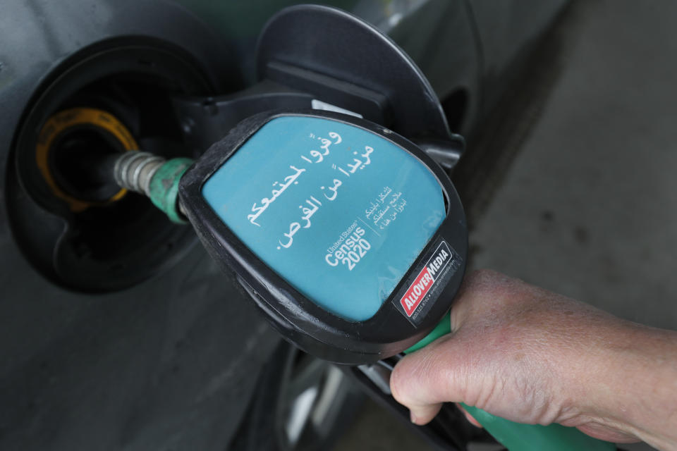 In this Thursday, April 30, 2020 photo, a gas pump message is obvious — at least to Arabic speakers: Be counted in the 2020 census. "Provide your community with more/additional opportunities," the ad on the pump handle reads in Arabic in Dearborn, Mich. The Arab American community checks many boxes that census and nonprofit officials say are hallmarks of the hardest-to-count communities: large numbers of young children, non-English speakers, recent immigrants and those who often live in multifamily or rental housing. (AP Photo/Carlos Osorio)