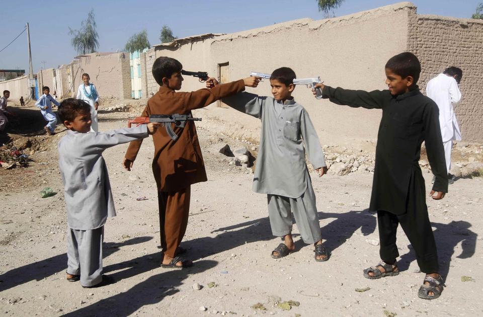 RNPS - PICTURES OF THE YEAR 2013 - Afghan boys play with toy guns on the first day of Eid al-Adha in Jalalabad October 15, 2013. Muslims around the world celebrate Eid al-Adha to mark the end of the haj pilgrimage by slaughtering sheep, goats, camels and cows to commemorate Prophet Abraham's willingness to sacrifice his son, Ismail, on God's command. REUTERS/Parwiz (AFGHANISTAN - Tags: RELIGION SOCIETY TPX)