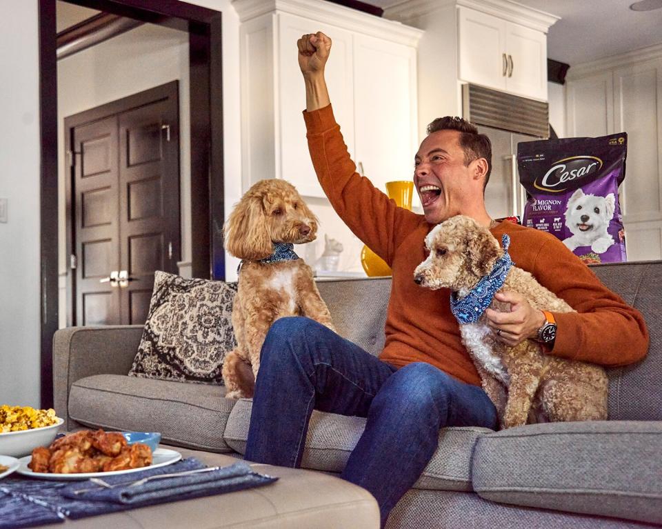 Jeff Mauro and his two pups, JoJo and Pinot G with CESAR® Filet Mignon Flavor &amp; Spring Vegetables Garnish Dry Dog Food in the background