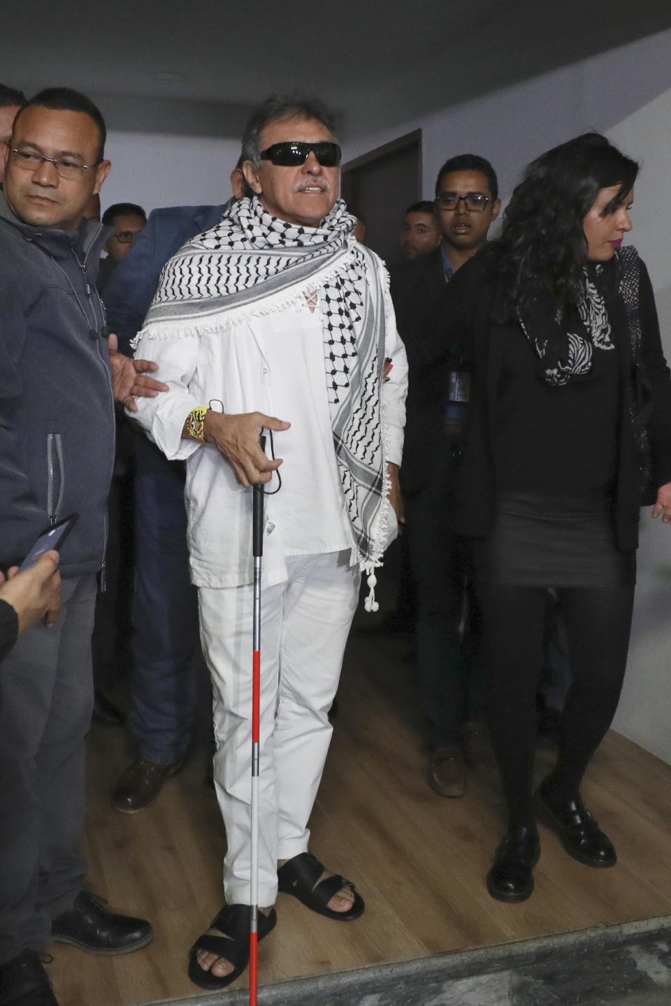 Former FARC rebel Jesus Santrich leaves Congress after swearing in to take his seat at the lower chamber in Bogota, Colombia, Tuesday, June 11, 2019. Santrich was unable to take up his seat in congress last year when he was jailed awaiting extradition to the U.S. on drug charges, but was since released in a decision by the special peace tribunal. (AP Photo/Fernando Vergara)