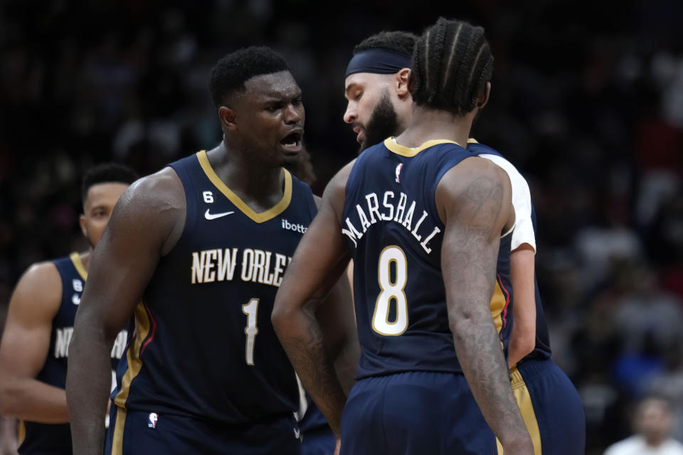 New Orleans Pelicans forward Zion Williamson (1) reacts with forward Naji Marshall (8) and forward Larry Nance Jr. during overtime of an NBA basketball game against the Phoenix Suns in New Orleans, Sunday, Dec. 11, 2022. The Pelicans won 129-124. (AP Photo/Gerald Herbert)