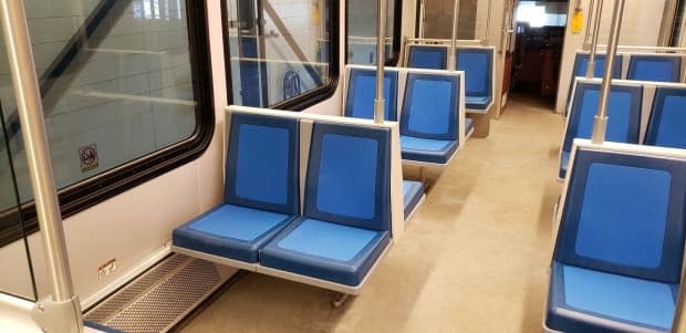 The old fabric seats are being replaced by these blue seats, which are made up of a harder rubber type material that includes a germ-killing additive. (Edmonton Transit Service - image credit)