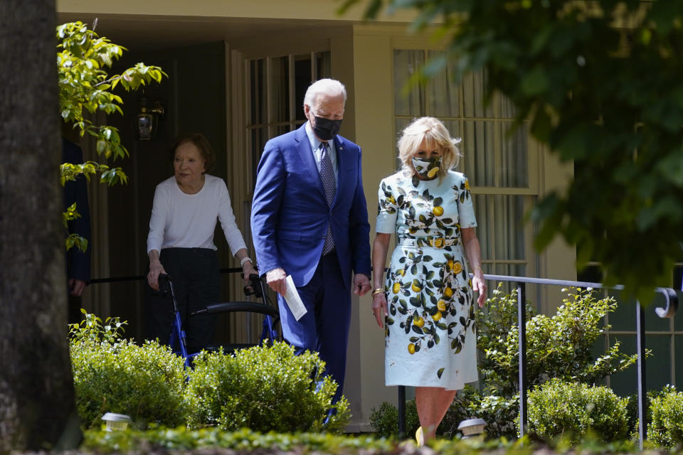 President Joe Biden and first lady Jill Biden walk with former first lady Rosalynn Carter as they leave the home of former President Jimmy Carter during a trip to mark Biden's 100th day in office, Thursday, April 29, 2021, in Plains, Ga. (AP Photo/Evan Vucci)