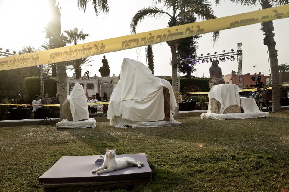 A cat sits in front of stone parts of the statue of King Psamtek l, before a press conference at the Egyptian museum in Cairo, Thursday, March 16, 2017. Egypt's antiquities minister Khaled el-Anani, told at a news conference that the colossus discovered last week in an eastern Cairo suburb almost certainly depicts Psamtek I, who ruled Egypt between 664 and 610 B.C. (AP Photo/Nariman El-Mofty)