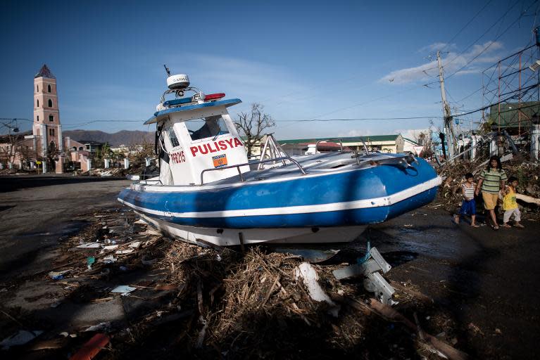 A boat washed ashore by Typhoon Haiyan stands in the middle of a crossroad in Tacloban, on the eastern island of Leyte, on November 15, 2013