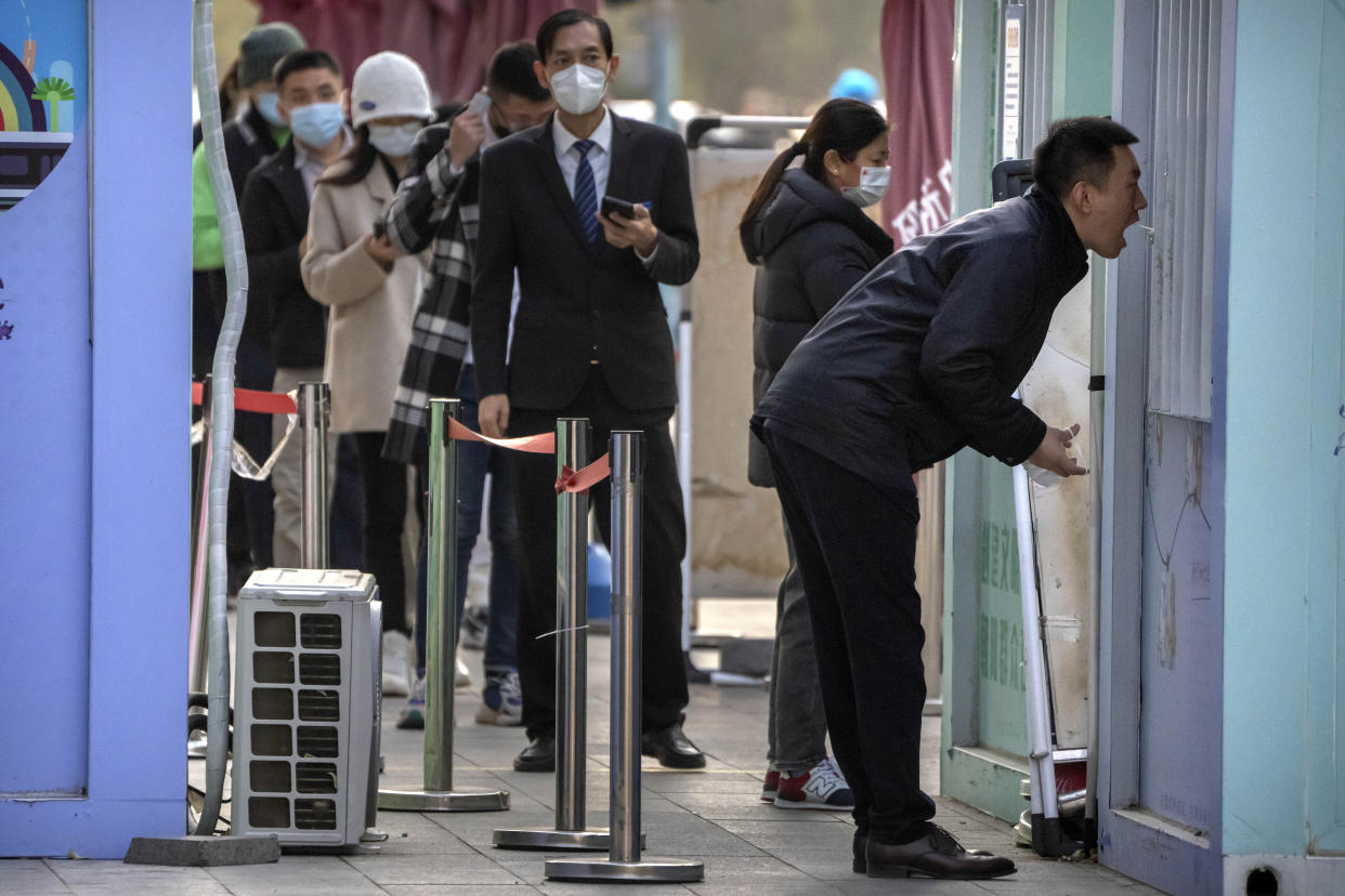 A man has his throat swabbed for a COVID-19 test at a coronavirus testing site in Beijing, Thursday, Nov. 17, 2022. Chinese authorities faced more public anger Thursday after a second child's death was blamed on overzealous anti-virus enforcement, adding to frustration at controls that are confining millions of people to their homes and sparked fights with health workers. (AP Photo/Mark Schiefelbein)