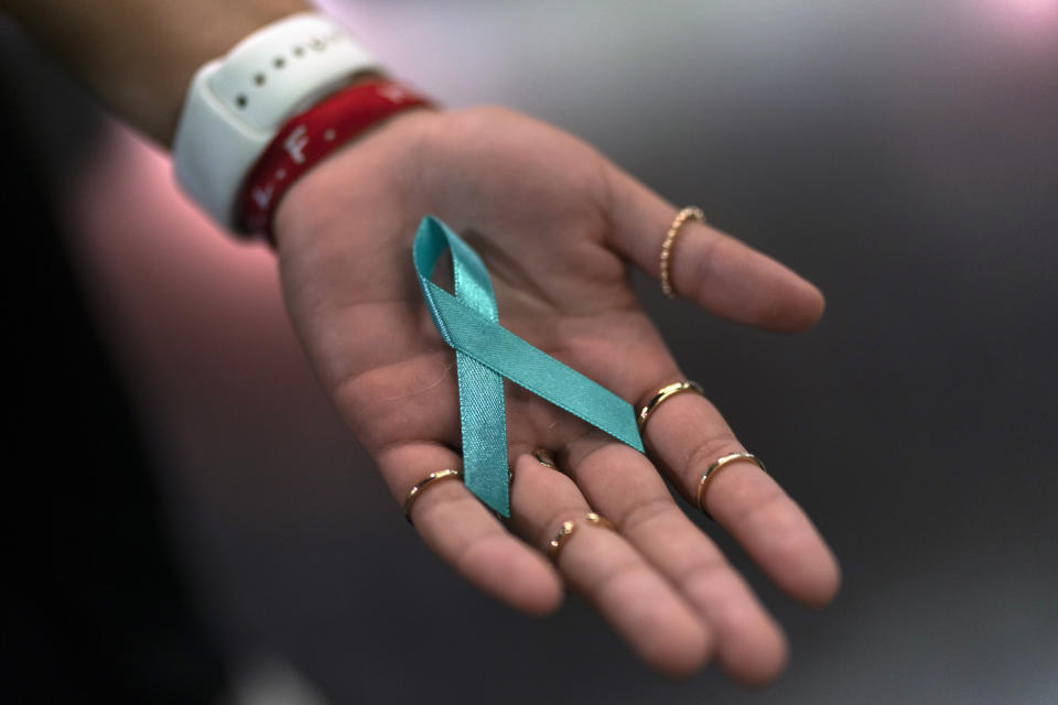 Sarah Barber shows a ribbon given to her by sexual abuse survivors at the Southern Baptist Convention’s annual meeting in Anaheim, Calif., Tuesday, June 14, 2022. (AP Photo/Jae C. Hong)