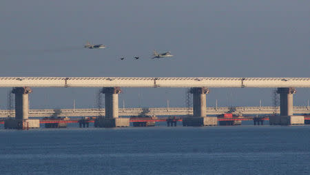 Russian jet fighters fly over a bridge connecting the Russian mainland with the Crimean Peninsula after three Ukrainian navy vessels was stopped by Russia from entering the Sea of Azov via the Kerch Strait in the Black Sea, Crimea November 25, 2018. REUTERS/Pavel Rebrov