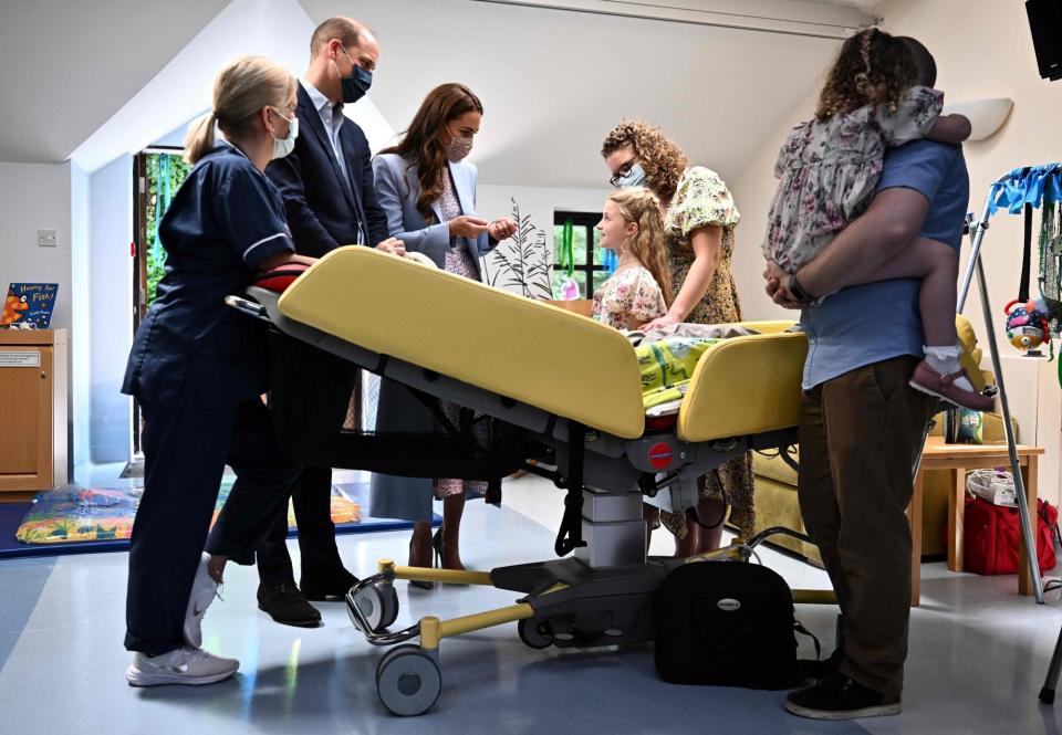 Prince William (2ndL), Duke of Cambridge, and Britain's Catherine (C), Duchess of Cambridge, meet with the family of William Carlson during a visit to East Anglia's Children's Hospices (EACH) in Milton