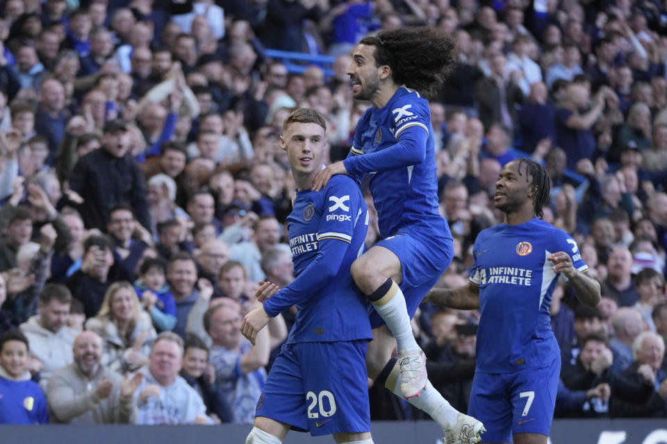 Chelsea's Cole Palmer, left, celebrates with teammates after scoring his sides second goal during the English Premier League soccer match between Chelsea and Burnley at Stamford Bridge in London, Saturday, March 30, 2024. (AP Photo/Kin Cheung)