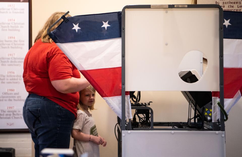 Donna Hatcher votes at the voting polls as Agnes Brooks, 5, watches her after voting on Super Tuesday for the 2024 United States primary elections in Nashville, Tenn., Tuesday, March 5, 2024.