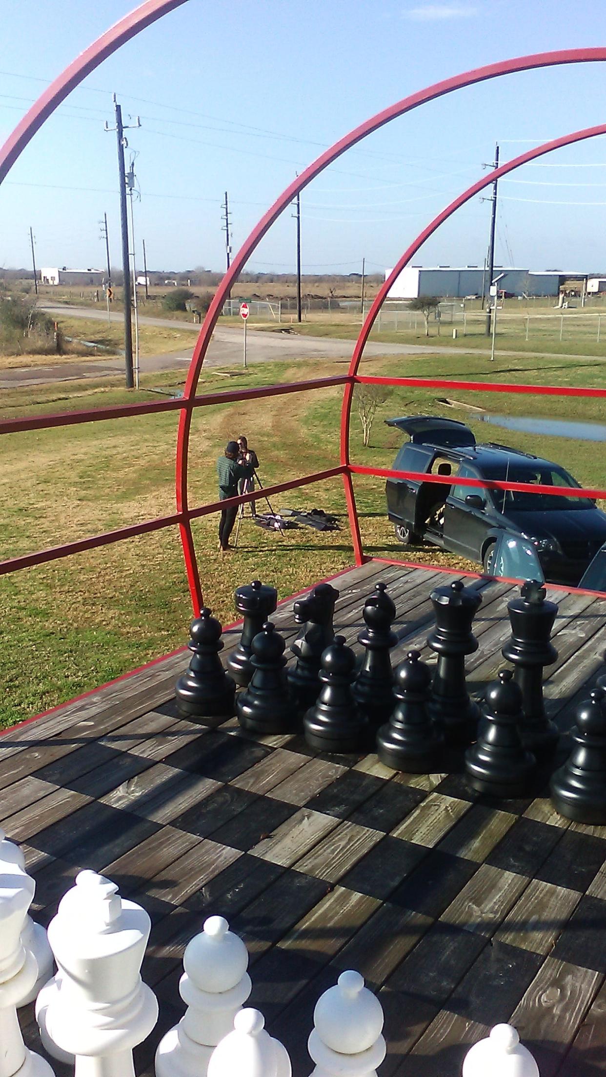 Life size chess set on the back of a renovated MD-80 plane house.