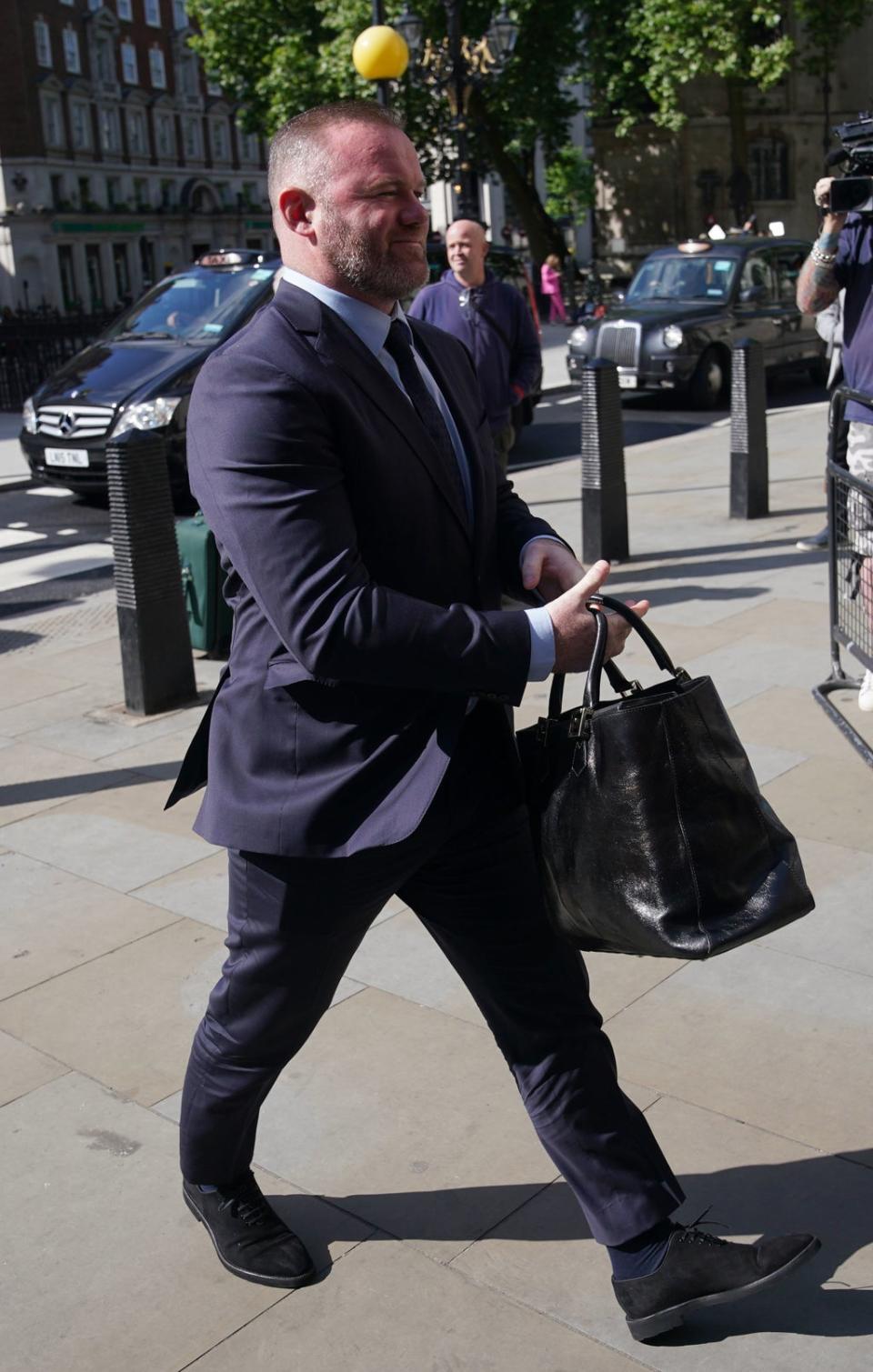 Wayne Rooney wears a blue suit on day six of the libel trial (PA)