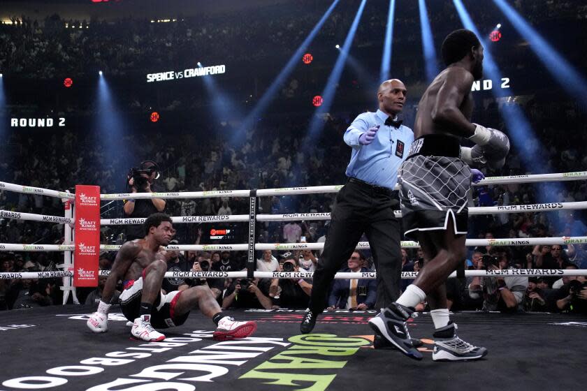 Errol Spence Jr., left, falls while fighting Terence Crawford during their undisputed welterweight championship boxing match, Saturday, July 29, 2023, in Las Vegas. (AP Photo/John Locher)