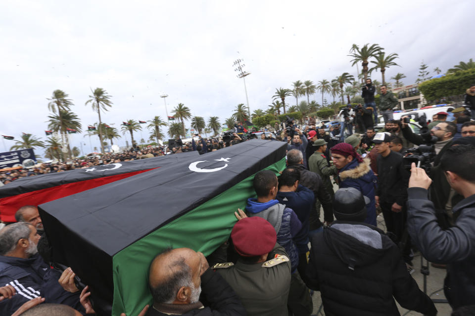 Mourners carry coffins during a funeral of military cadets in Tripoli, Libya, Sunday, Jan. 5, 2020. Health officials said the death toll from the airstrike climbed to at least 30 people, most of them students and over 30 others were wounded. The airstrike took place in the city's south late Saturday, an area which has seen heavy clashes in recent months. Forces based in eastern Libya and led by Gen. Khalifa Hifter have been fighting to seize the capital from the weak but U.N.-supported government. (AP Photo/Hazem Ahmed)