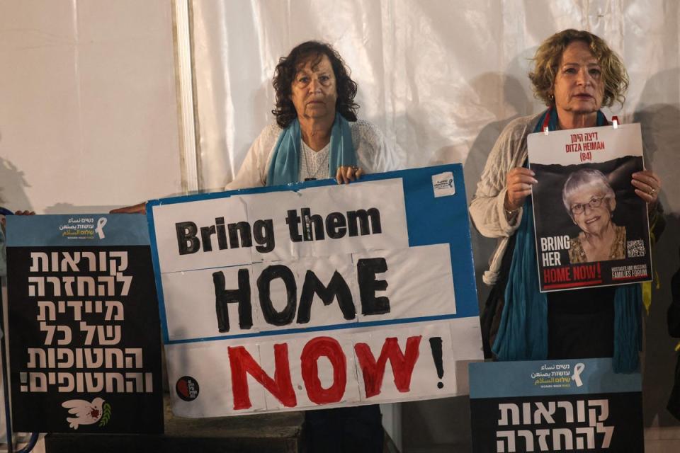 Relatives and friends of Ditza Heiman in Tel Aviv call for her release (AFP via Getty Images)