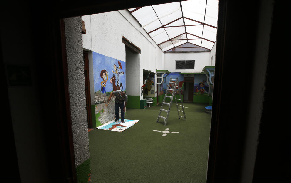 CORRECTS NAME - Administrative assistant Joel Barba works on a restoration project at La casa del Colibri kindergarten, which remains closed due to the new cornavirus pandemic, in Mexico City, Tuesday, April 20, 2021. The Mexican government began giving teachers in five other states the single-dose CanSino COVID-19 vaccine to speed up their return to the classroom before the end of the school year in July. (AP Photo / Marco Ugarte)