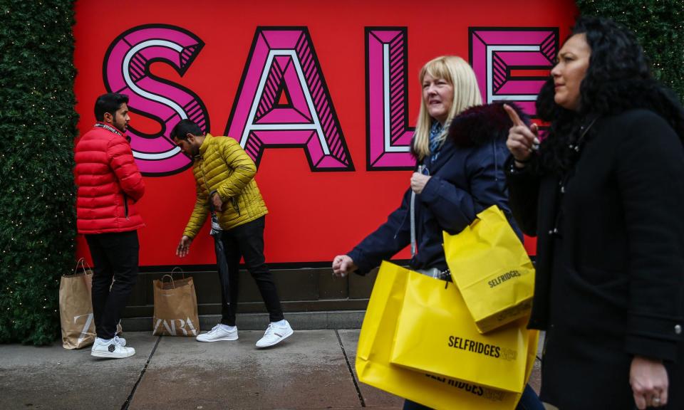 <span>West End shoppers armed with Selfridges bags in London.</span><span>Photograph: Hollie Adams/Getty Images</span>