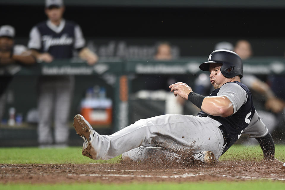 New York Yankees' Luke Voit scores on a passed ball during the sixth inning of the team's baseball game against the Baltimore Orioles on Sunday, Aug. 26, 2018, in Baltimore. The Yankees won 5-3. (AP Photo/Gail Burton)