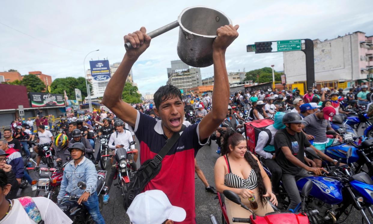 <span>People protest the official election results declaring President Nicolás Maduro the winner of the presidential election, the day after the vote in Caracas, Venezuela, on Monday.</span><span>Photograph: Fernando Vergara/AP</span>