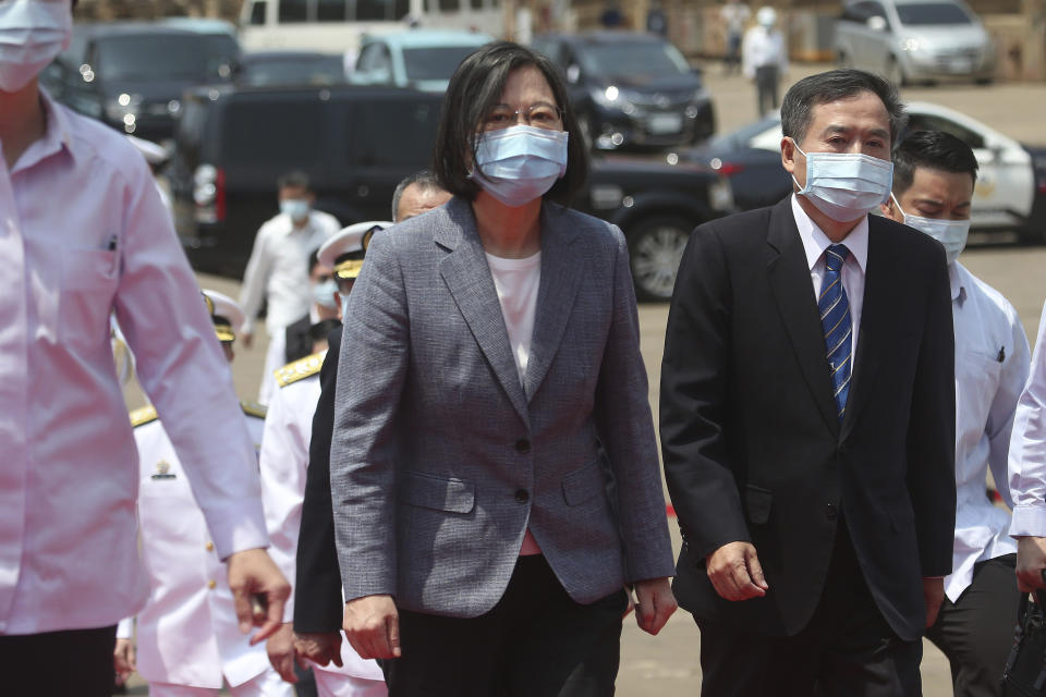 Taiwan's President Tsai Ing-wen, center, walks to take part in a launch ceremony for its first indigenous amphibious transport dock in Kaohsiung, southern Taiwan, Tuesday, April 13, 2021. (AP Photo/Chiang Ying-ying)