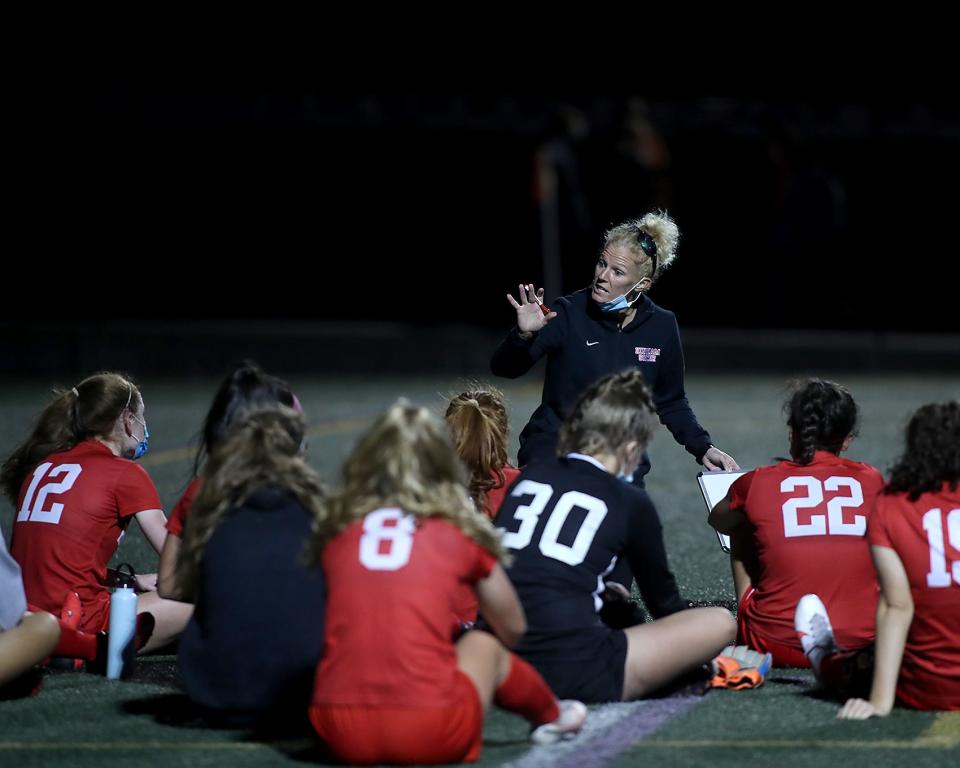 Head coach Sarah Dacey talks to her team at halftime of their game against Pembroke in the Patriot Cup at Hingham High on Wednesday, Nov. 11, 2020. 