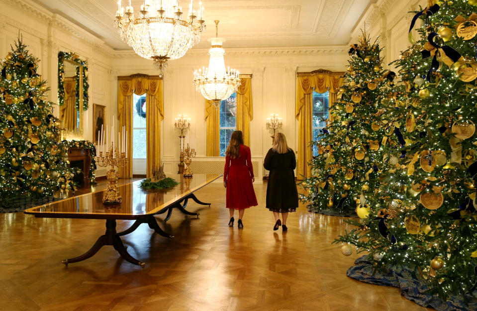 Staff members walk through the decorated East Room during the 2018 Christmas Press Preview at the White House in Washington, D.C., Nov. 26, 2018. (Photo: Leah Millis/Reuters)