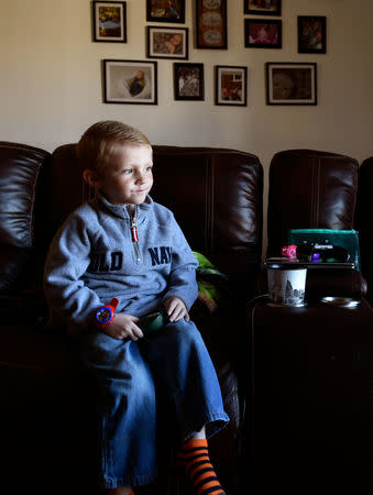 Stephanie Oakley's son, who has a rare form of cancer, sits in their new mold-free home in Oklahoma City, Oklahoma, U.S. November 26, 2018. REUTERS/Nick Oxford