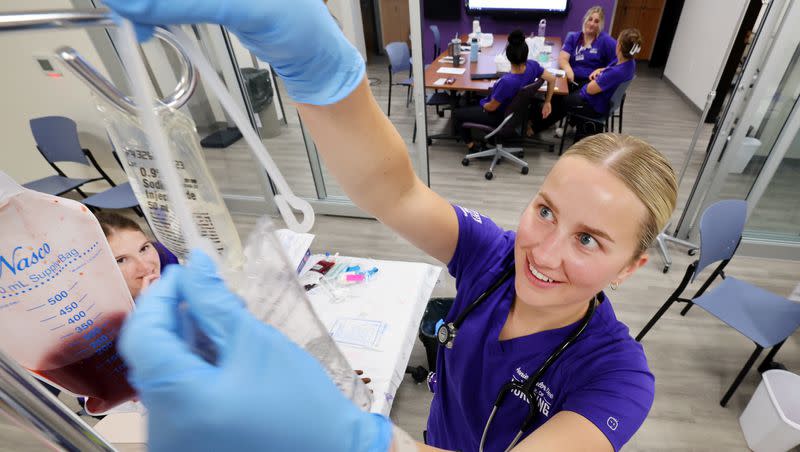 Nursing student Kira Fujikawa hangs a fluid bag as she and Rachel Sessions and other nursing students work in the simulation lab in the Marriott Health Building at Weber State University in Ogden on Tuesday, Sept. 5, 2023.