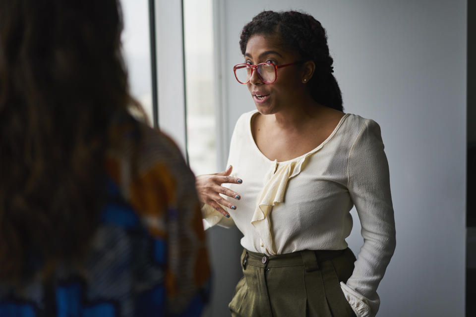 A woman talking to her coworker