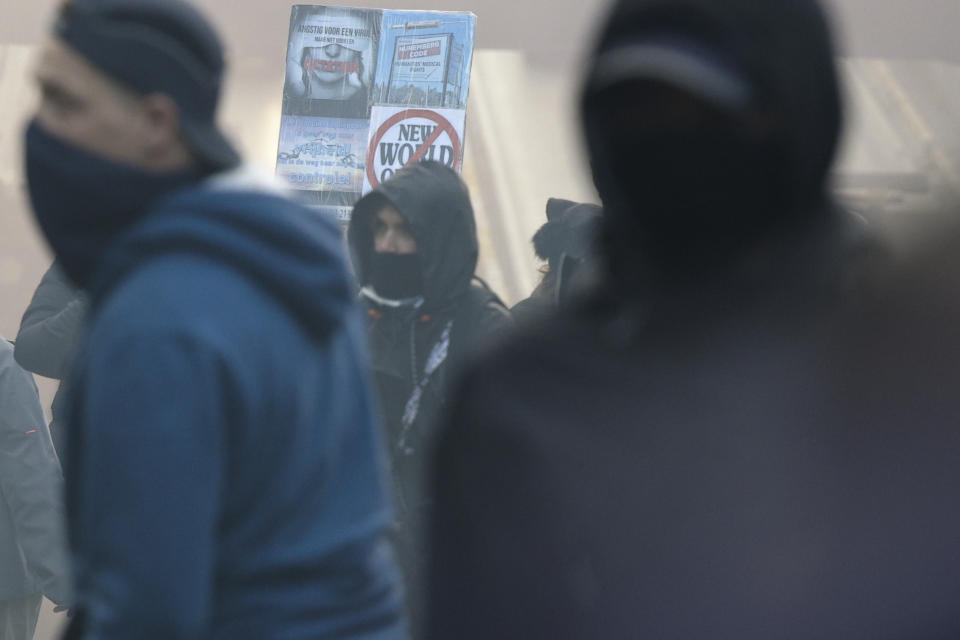 Protestors has covered their faces a demonstration against the reinforced measures of the Belgium government to counter the latest spike of the coronavirus in Brussels, Belgium, Sunday, Nov. 21, 2021. Many among them also protested against the strong advice to get vaccinated and any moves to impose mandatory shots. (AP Photo/Olivier Matthys)