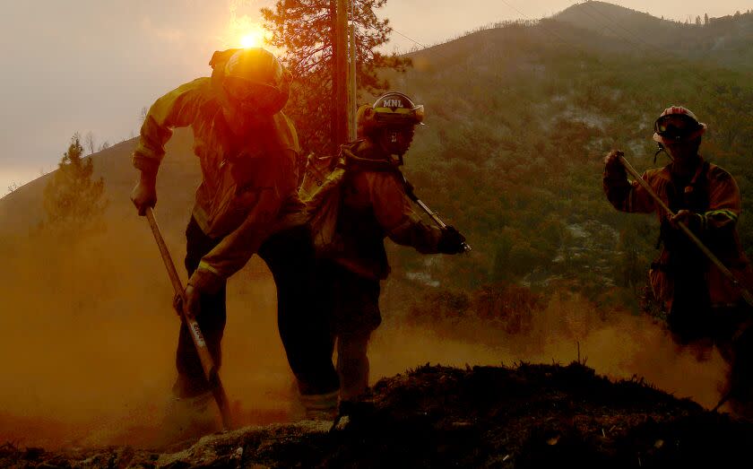 MARIPOSA, CALIF. - JULY 26, 2022. Firefighters put out hotspots from the Oak fire along Darrah Road near Mariposa on Tuesday, July 26, 2022. (Luis Sinco / Los Angeles Times)