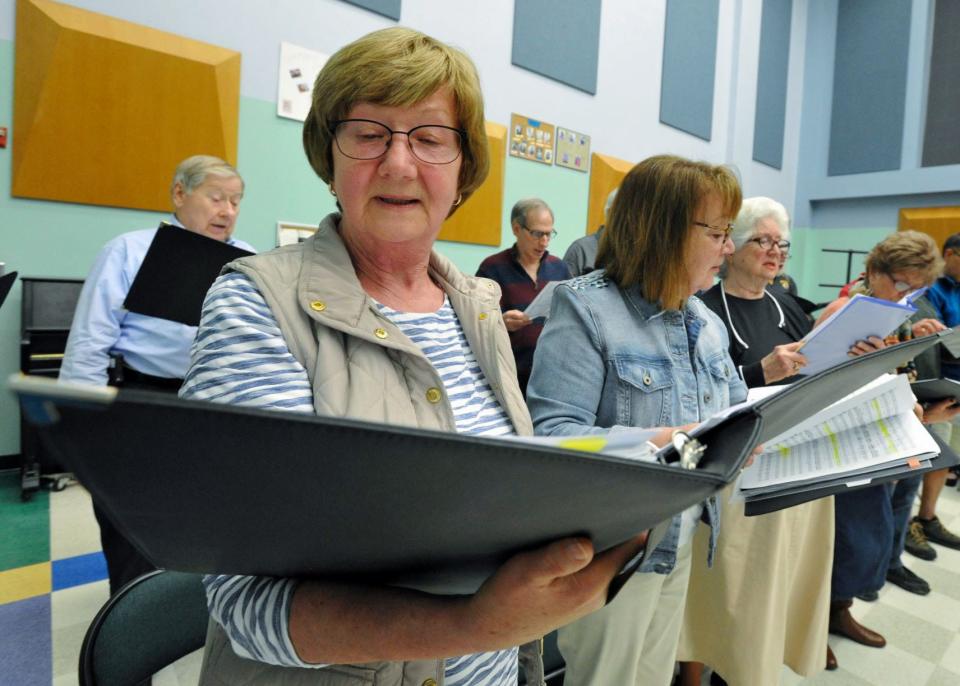 Laurie Gibbons, of Duxbury, joins other members of the Snug Harbor Community Chorus rehearsing for their upcoming 25th anniversary concert at the Duxbury Performing Arts Center. Monday, May 3, 2022.