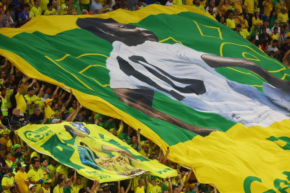 Soccer Football - FIFA World Cup Qatar 2022 - Round of 16 - Brazil v South Korea - Stadium 974, Doha, Qatar - December 5, 2022 Fans inside the stadium hold up a banner of former Brazil player Pele with the message get well soon REUTERS/Paul Childs TPX IMAGES OF THE DAY