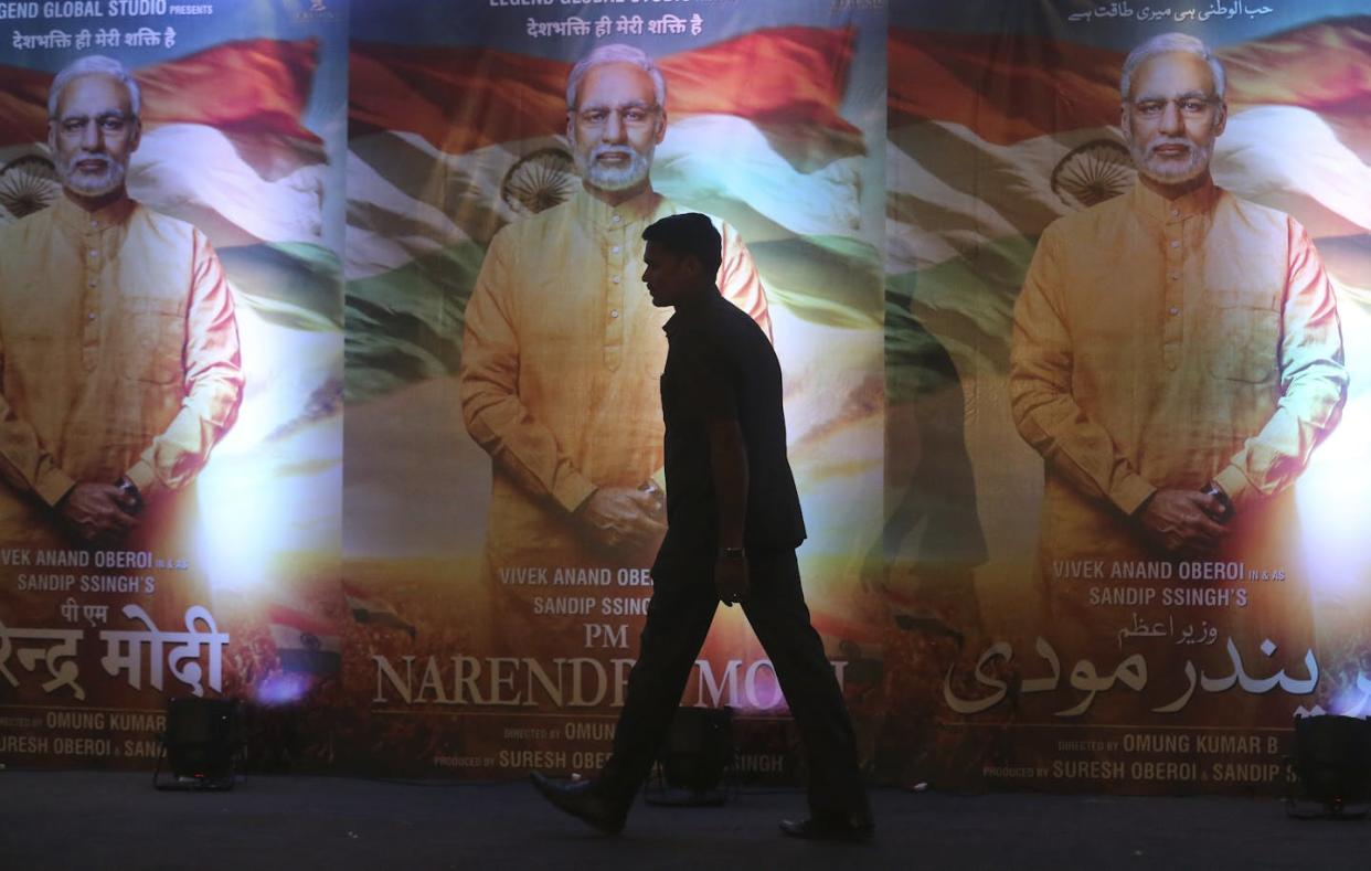 A man walks past posters of the film 'PM Narendra Modi,' a biopic on the Indian prime minister, during its launch in Mumbai, India, in 2019. <a href="https://newsroom.ap.org/detail/IndiaBollywood/01da09f305ce4ba38cfef5e9aecdf8ef/photo?Query=india%20elections%20modi%20cinema%20films&mediaType=photo&sortBy=&dateRange=Anytime&totalCount=1257&digitizationType=Digitized&currentItemNo=0&vs=true&vs=true" rel="nofollow noopener" target="_blank" data-ylk="slk:AP Photo/Rafiq Maqbool;elm:context_link;itc:0;sec:content-canvas" class="link ">AP Photo/Rafiq Maqbool</a>
