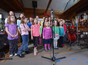 Children of Newton, CT perform "A Song From Sandy Hook" with Ingrid Michaelson (C) at the home of Chris Frantz and Tina Weymouth of the Talking Heads on January 14, 2013 in Fairfield, Connecticut. (Photo by Michael Loccisano/Getty Images for Tim Hayes)