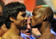 Boxers Manny Pacquiao (L) of the Philippines and Timothy Bradley of US stand face to face during the weigh-in session at the MGM Grand Arena in Las Vegas, Nevada on June 08,2012. Pacquiao and Bradley will fight on June 9. AFP PHOTO / JOE KLAMARJOE KLAMAR/AFP/GettyImages