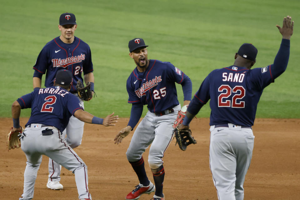 Minnesota Twins players Luis Arraez (2) Trevor Larnach (24), Byron Buxton (25) and Miguel Sano (22) celebrate their victory over the Texas Rangers in a baseball game Saturday, June 19, 2021, in Arlington, Texas. (AP Photo/Michael Ainsworth)